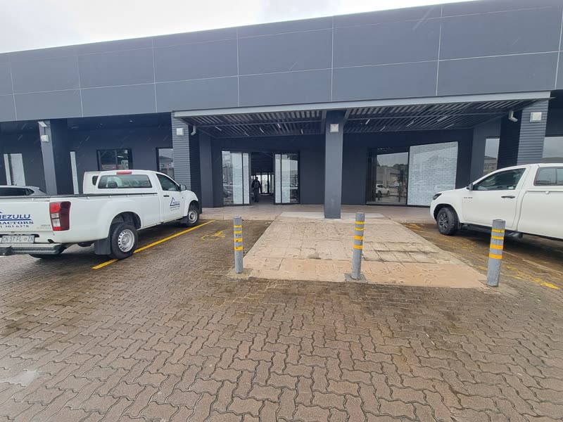 Completed commercial building with a covered colonnade and parking bays