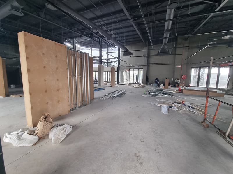 Internal fit-out under way in a commercial unit with services exposed overhead