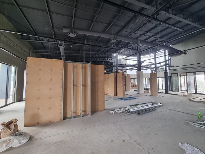 Partition boards standing ready in a commercial unit with services exposed overhead