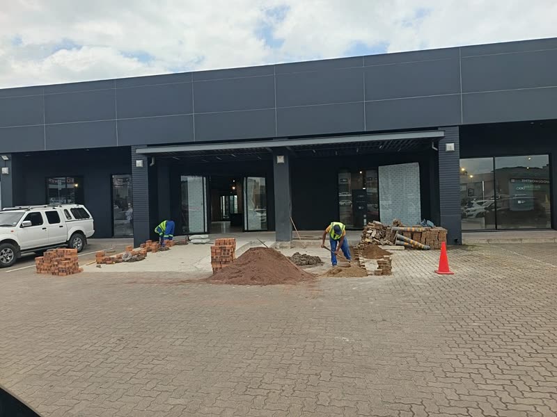 Completed retail frontage with the block paving and planting being finished