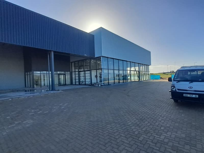Showroom building and paved forecourt seen from the entrance approach