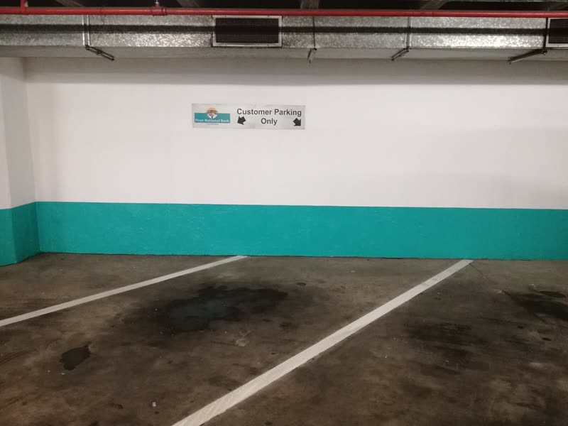 Parking bays set out and marked against a freshly painted dado