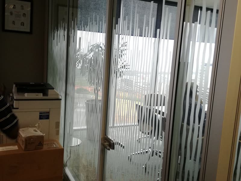 Frosted-banded glazed partitions dividing a fitted-out office floor