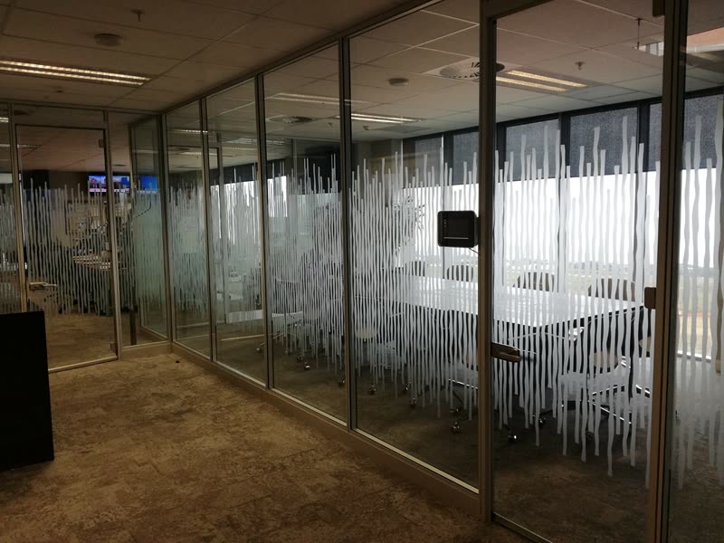 Glazed office partitioning installed along a fitted-out floor plate
