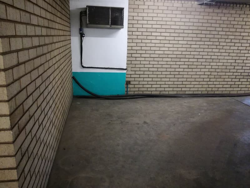 Face-brick wall and painted dado completed alongside a resurfaced parking floor