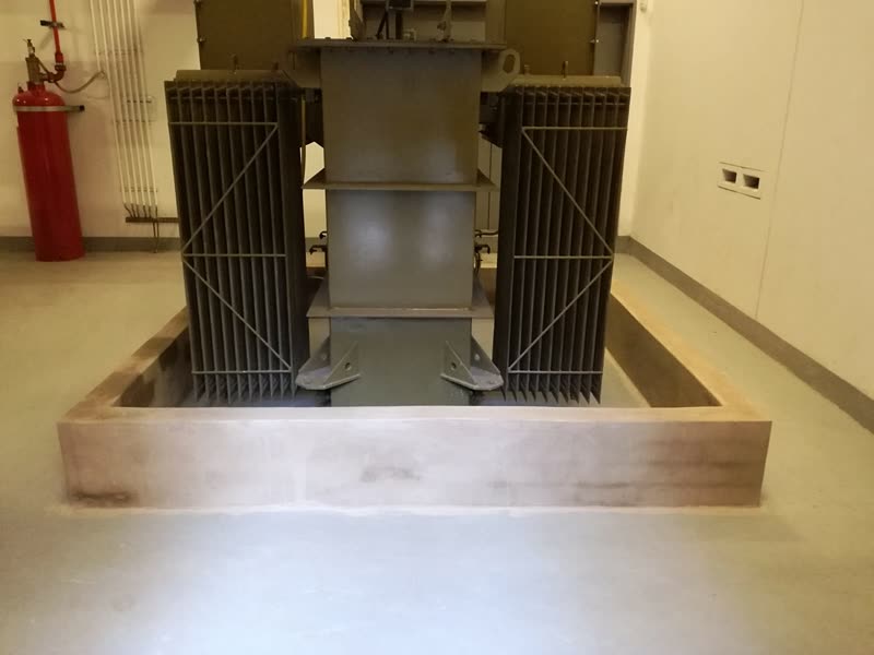 Close view of transformer radiators and mountings within the bunded plinth