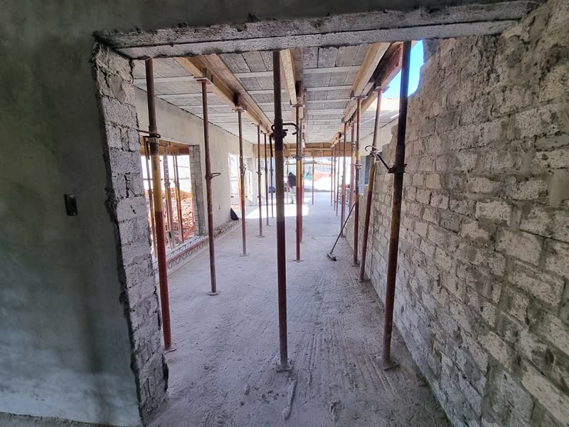 Internal shell of a house with block walls, openings formed and props in place