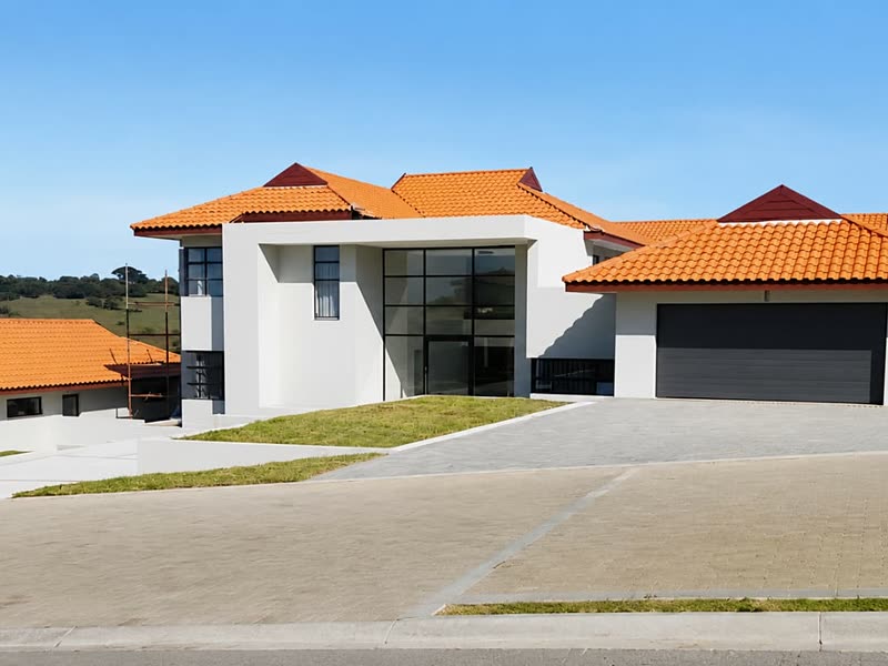 Street elevation of a completed home with a terracotta roof and double garage